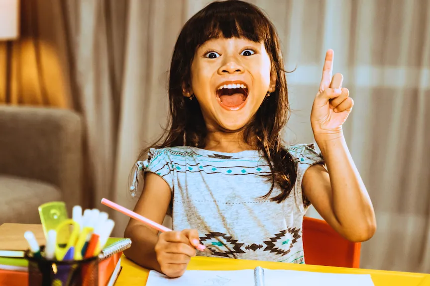 Little girl smiling while drawing